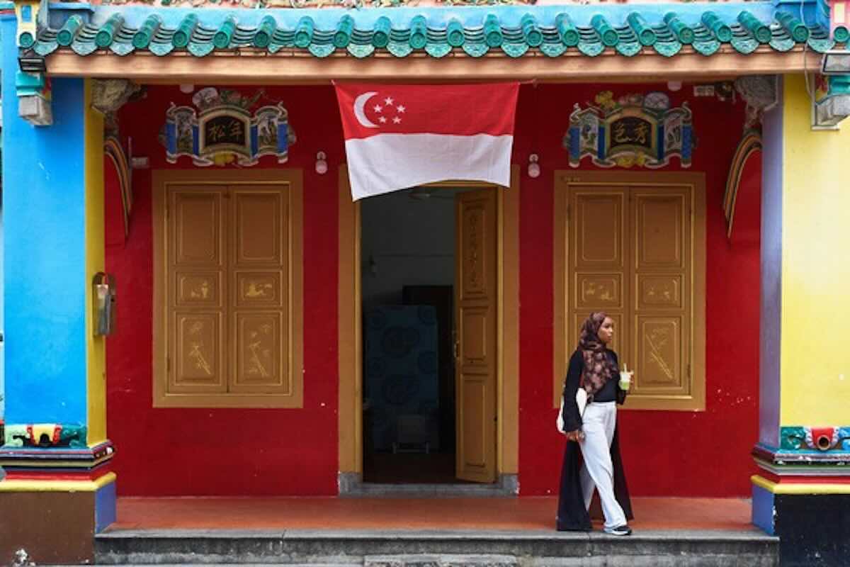 Singapore flag displayed outside a heritage building, illustrating the Singapore context for calculating life insurance returns and policy comparisons.