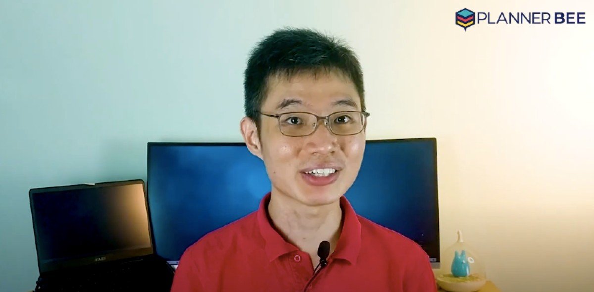 Finance content creator recording a personal finance video in a home office studio.
