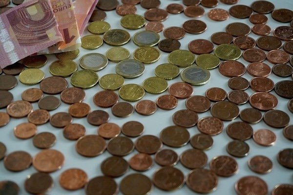 Scattered coins on top of a table