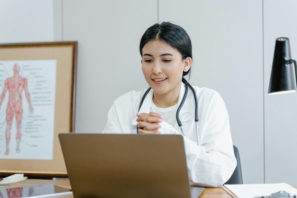 Female doctor looking at laptop