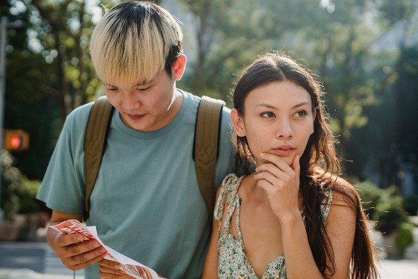 A lost couple trying to find directions on a map