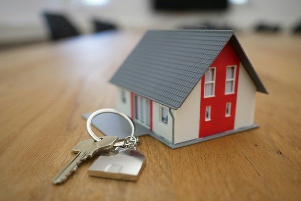 Miniature house and key at the top of the table
