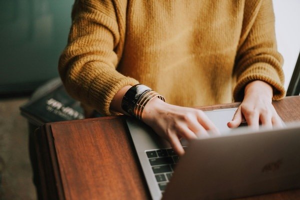 A person using a laptop on the table
