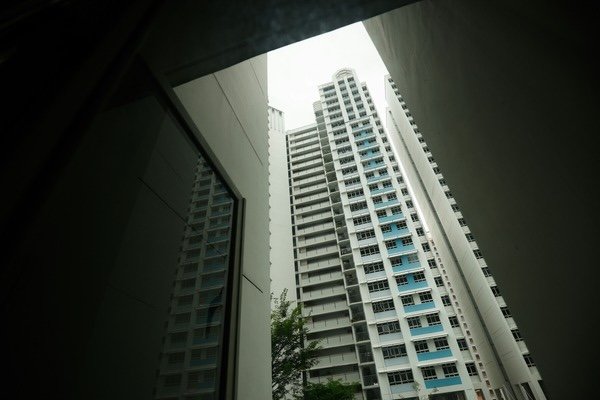 A tall white building with blue balconies