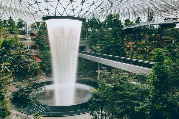 Jewel Changi Airport's indoor waterfall and lush greenery, showcasing Singapore's Green Plan 2030 and its focus on sustainable urban development.