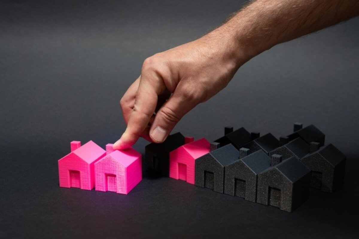 Hand selecting a model house, illustrating important decisions when buying property in Malaysia.