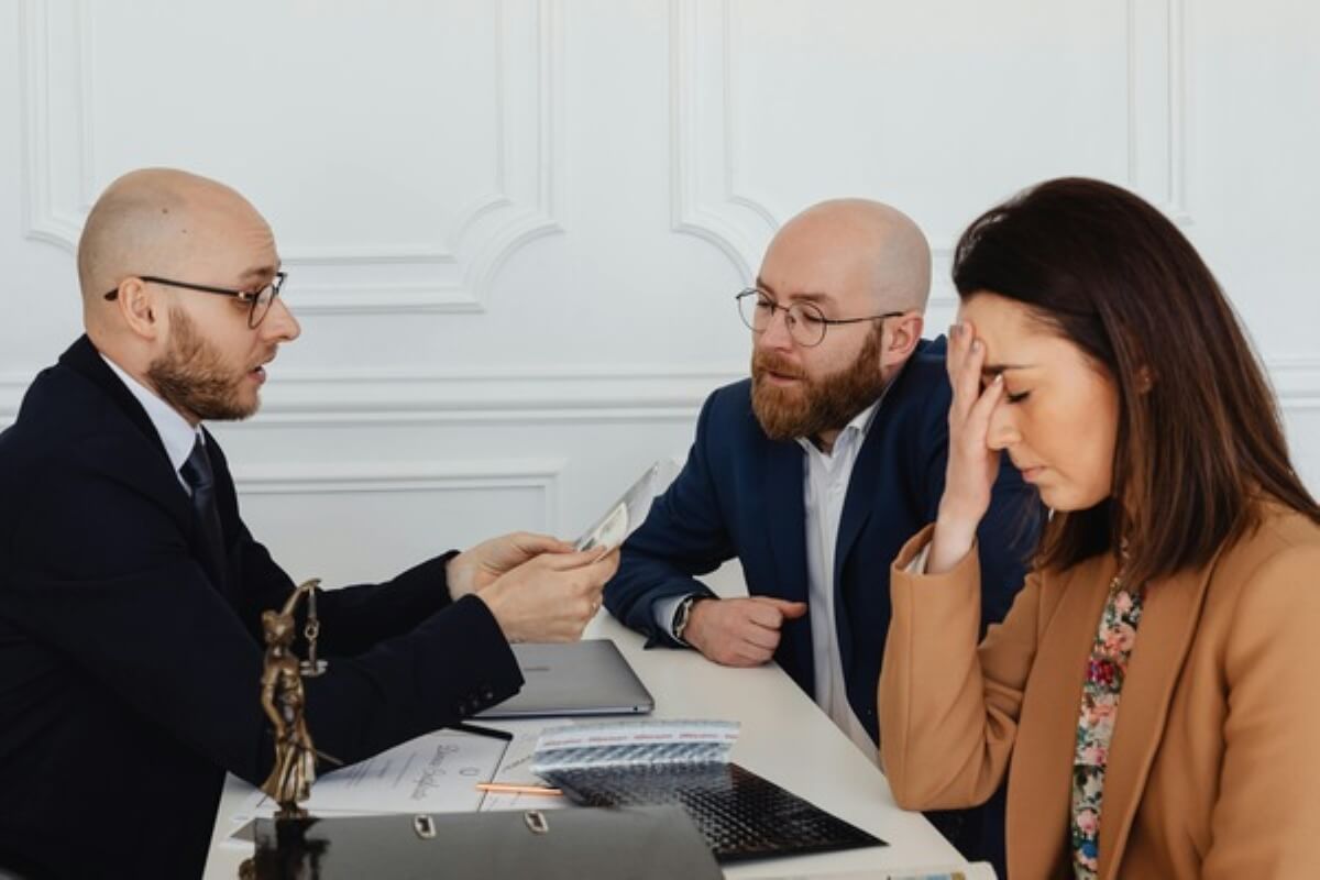 Property lawyer advising a couple on documents and regulations before buying property in Malaysia.