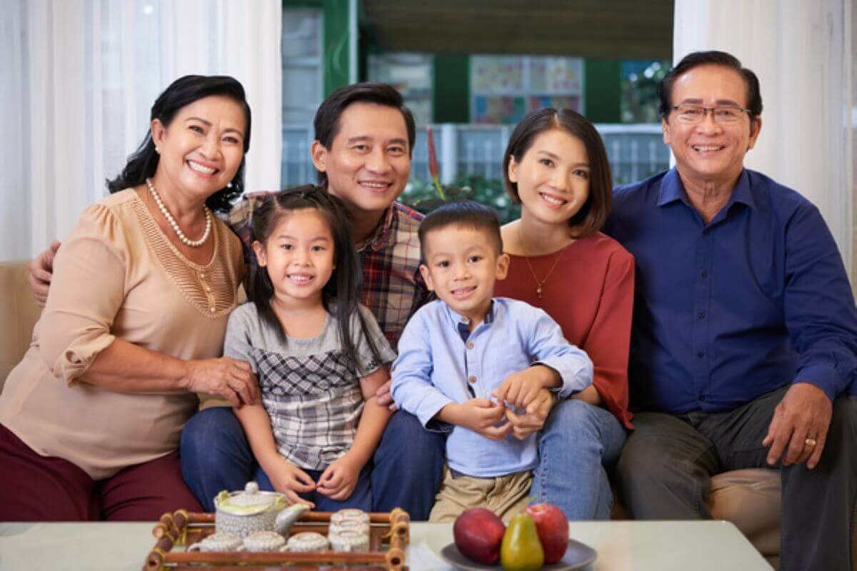 Three-generation family together at home, showing how disability income insurance helps protect household finances if a working adult becomes disabled.