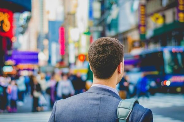 Professional walking through a busy city, representing career opportunities and employment rights in Singapore for employees and job seekers.