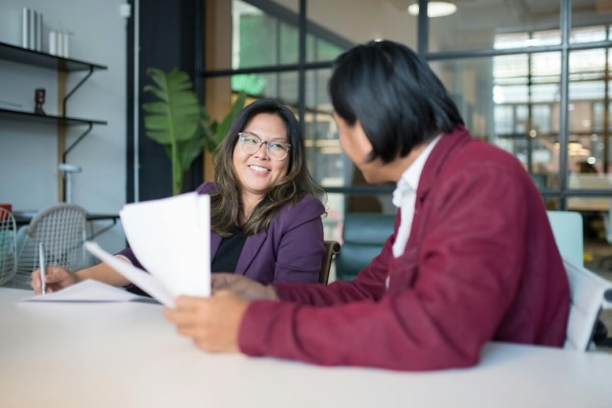 Insurance adviser discussing policy options with a client to help with buying insurance decisions.