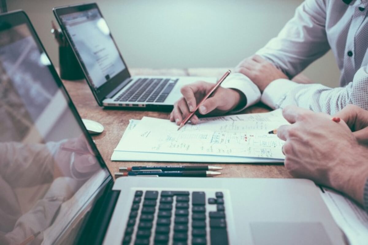 Financial advisers reviewing policy details and coverage options for clients buying insurance.