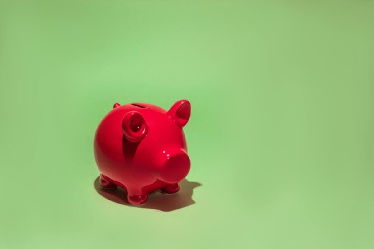 Red piggy bank symbolising emergency savings for a successful midlife career change.