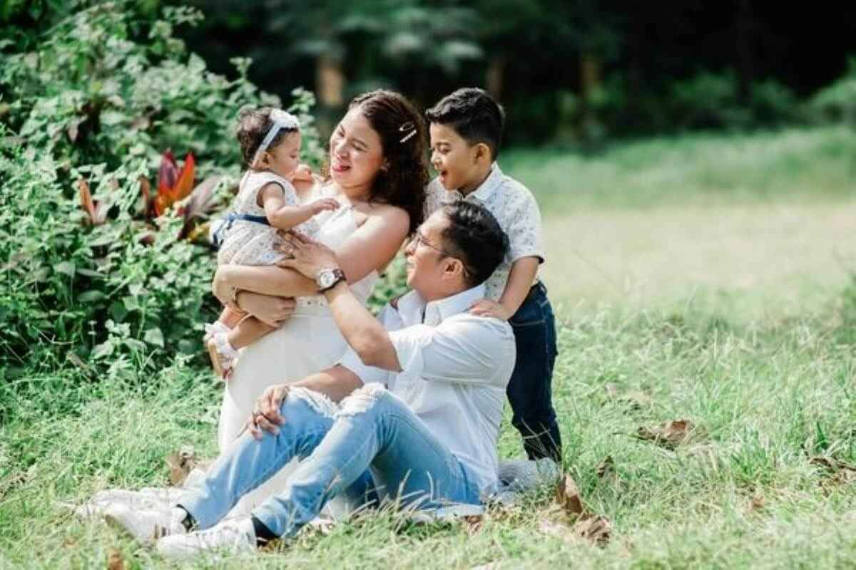 Parents spending time with their young children outdoors, highlighting legacy planning to protect their family’s future.