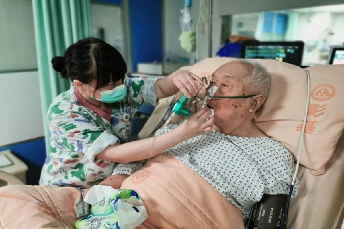 Nurse helping an elderly patient with oxygen support, showing how legacy planning can prepare families for healthcare and end-of-life needs.