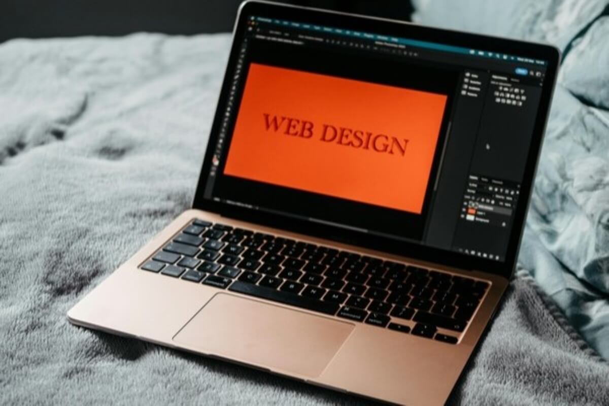 Laptop displaying a web design project, showing how creative skills can help you grow your side hustle into a business.