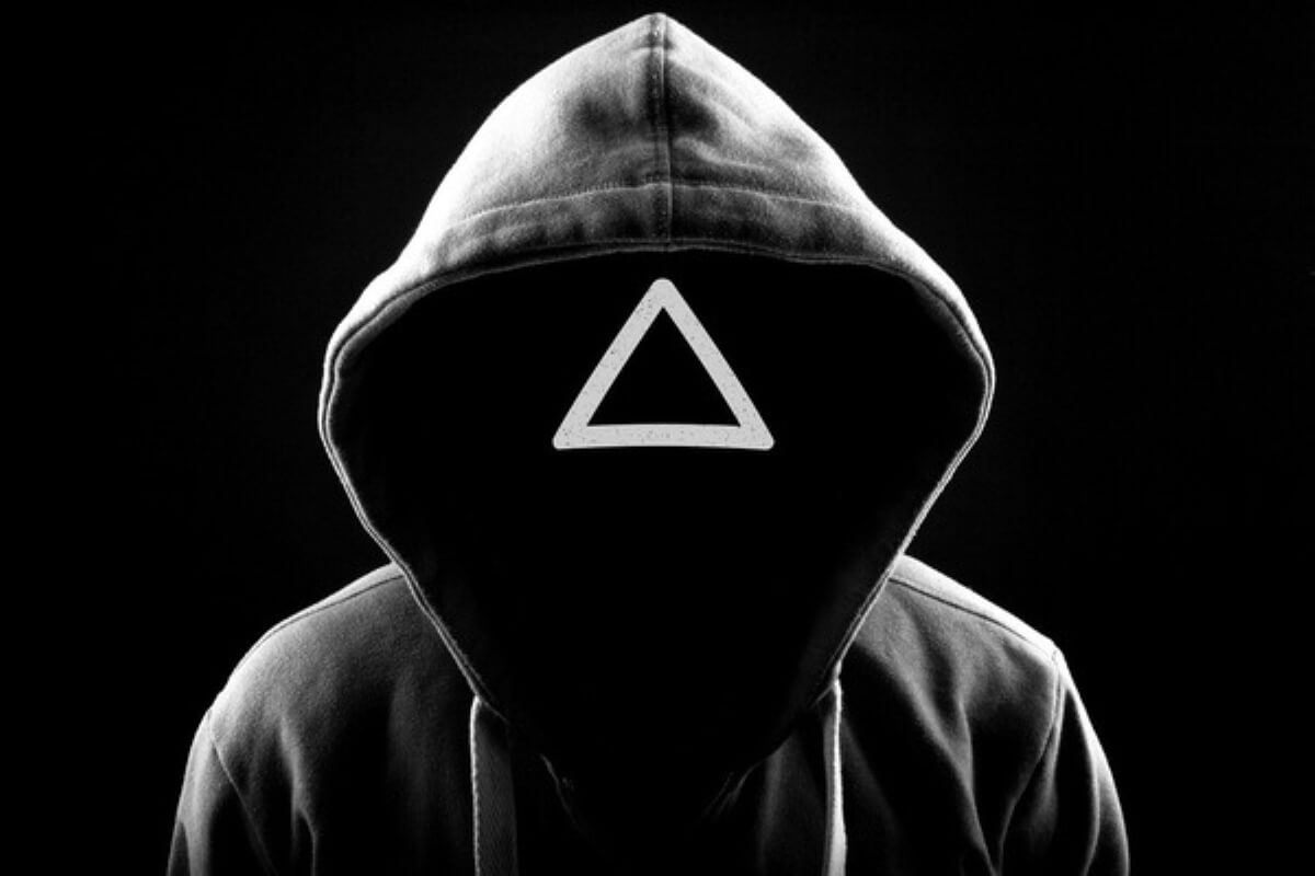 Masked Squid Game guard with a triangle symbol, representing power, risk and money lessons about greed and financial pressure.
