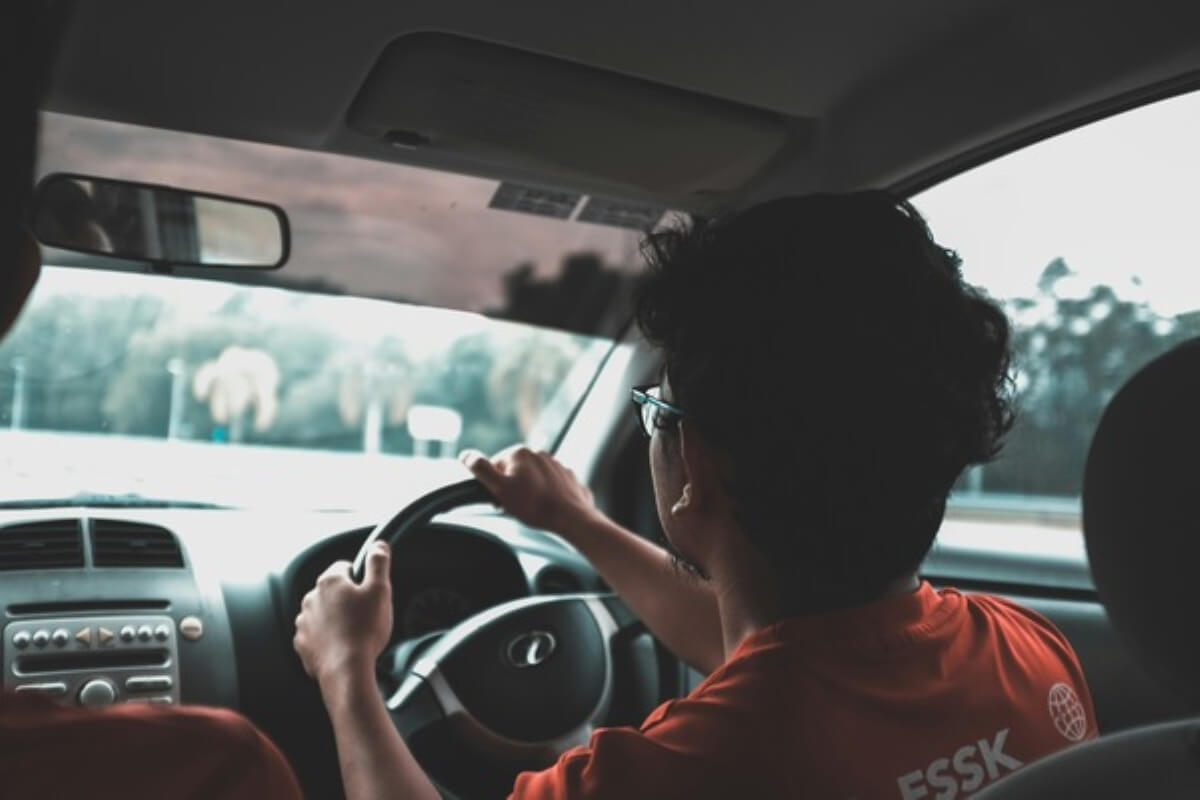 Driver behind the wheel, representing the everyday driving experience of electric vehicles.