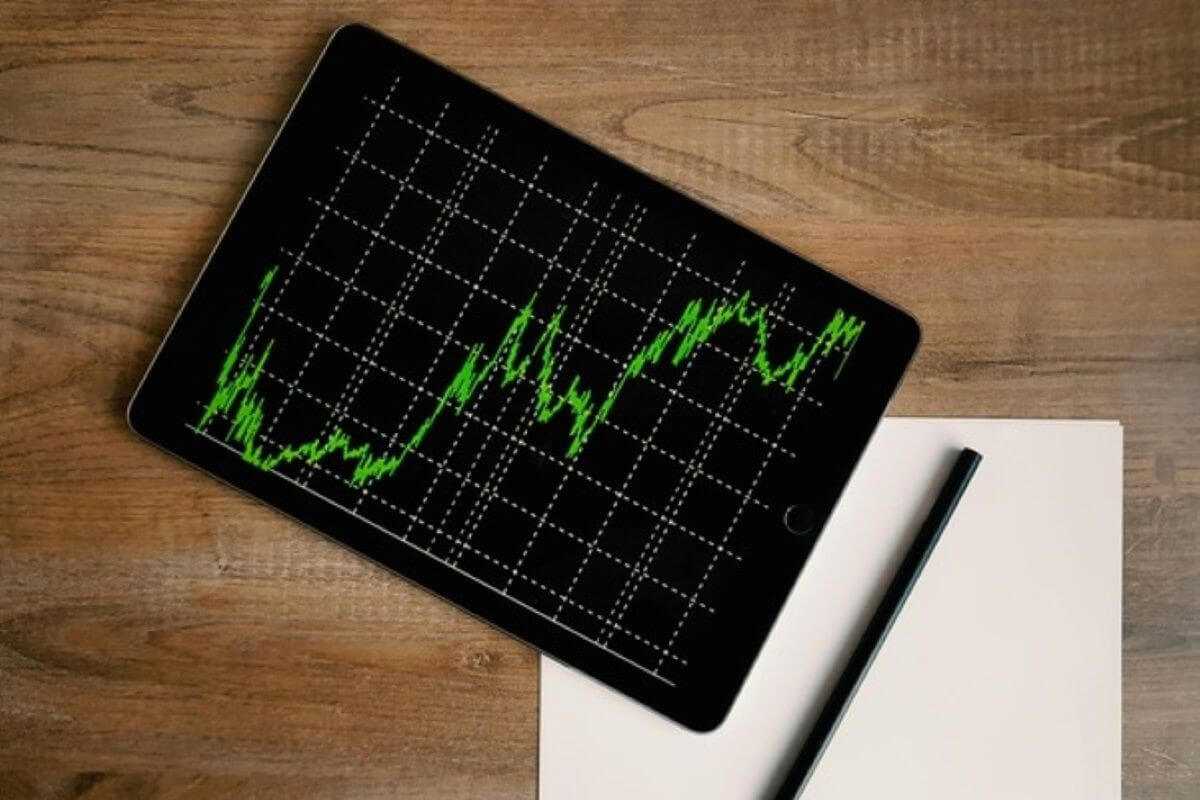 Tablet displaying a rising investment chart, illustrating how investing early can help make your child a millionaire.