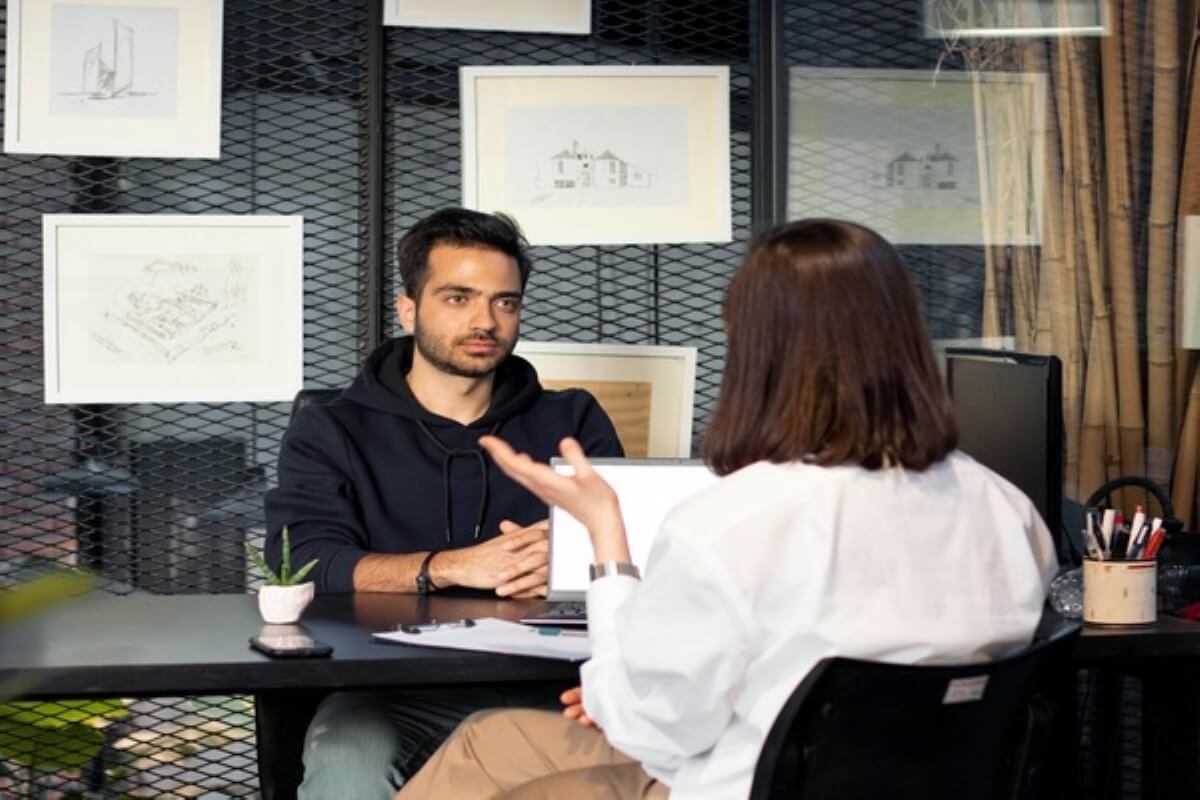 Job candidate discussing salary expectations with a hiring manager during an interview, illustrating strategies for negotiating the job offer.