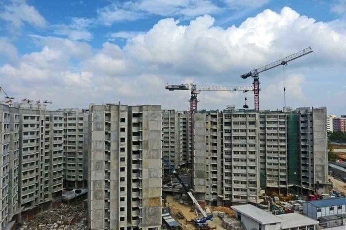 HDB blocks under construction with cranes overhead, illustrating the progress and risks of buying property under construction in Singapore.