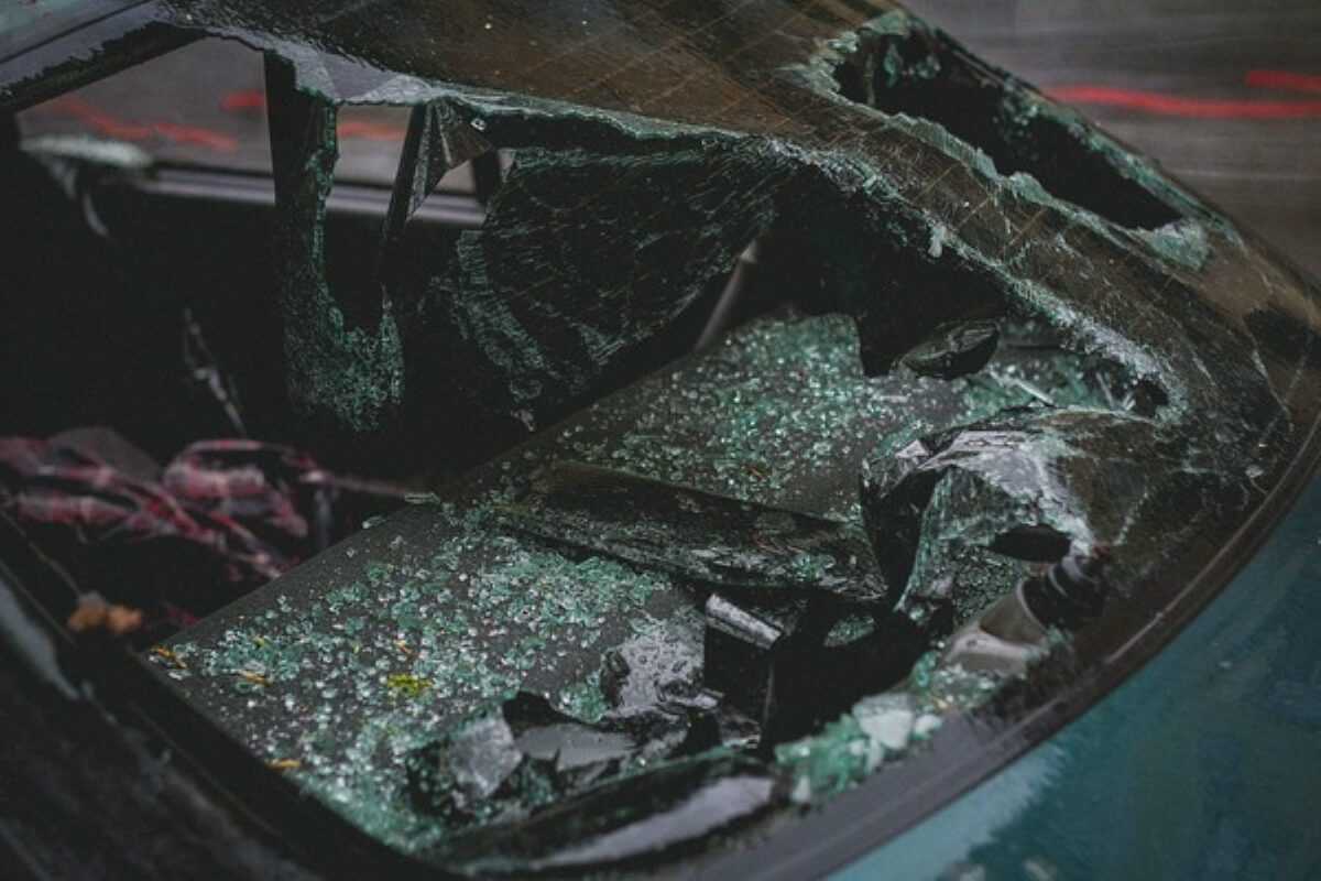 Close-up of a shattered car windscreen caused by an accident, illustrating Singapore car insurance coverage for windscreen repairs.