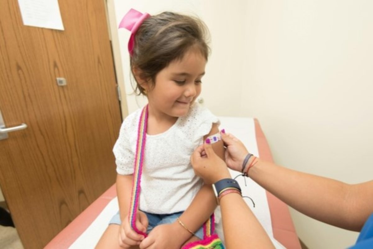 Young child receiving flu shots during a routine vaccination appointment.