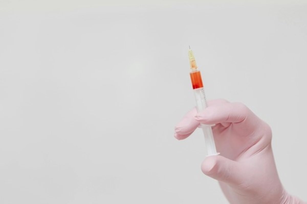 Healthcare professional holding a syringe before administering flu shots at a vaccination clinic.