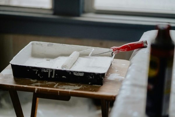 Paint tray and roller prepared for interior painting, representing painting expenses in renovation costs in Singapore.