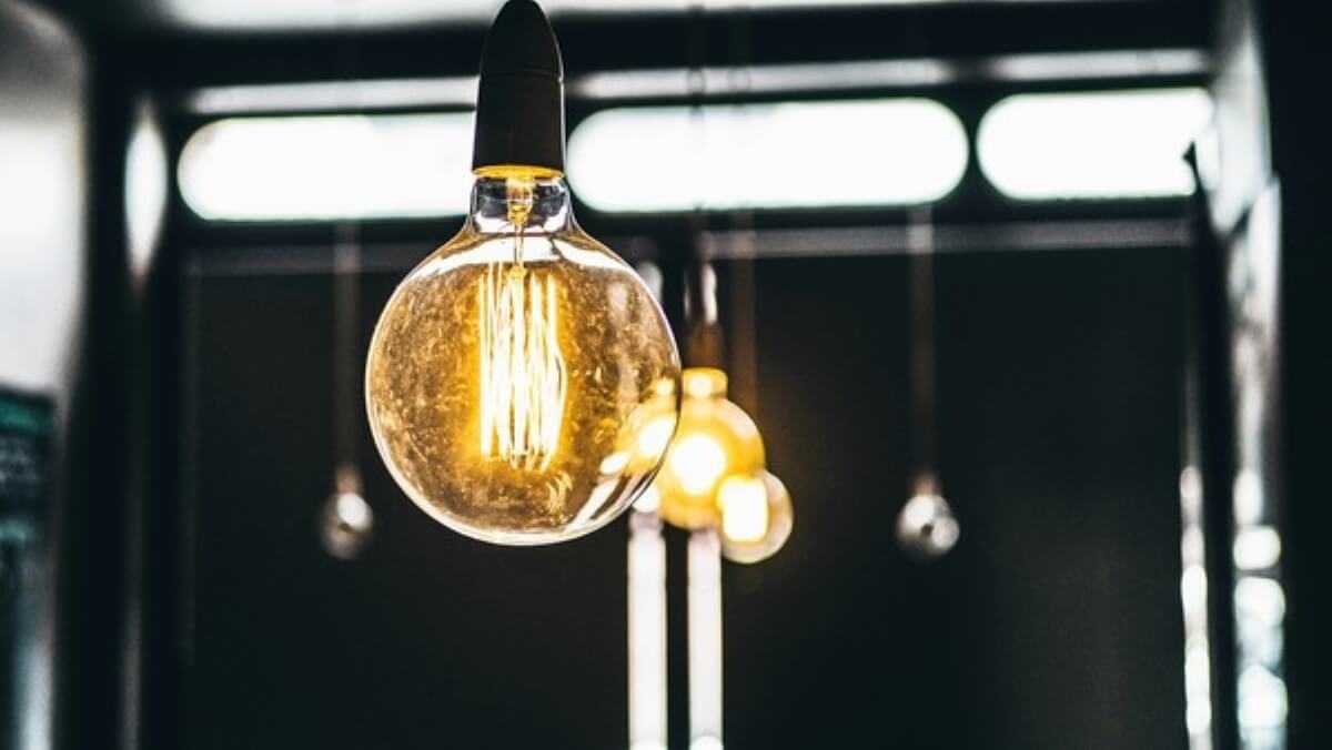 Vintage light bulbs hanging from the ceiling, highlighting lighting fixtures that add to renovation costs in Singapore.