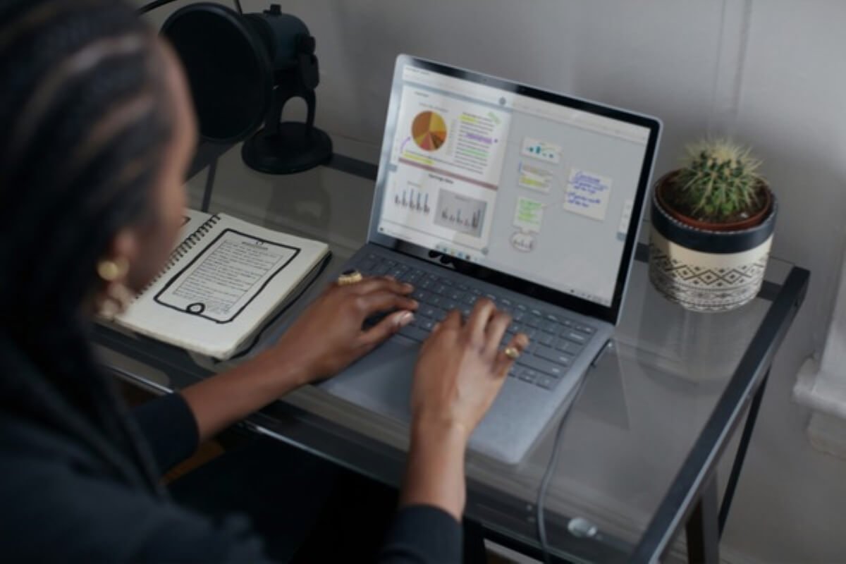 Professional reviewing charts and reports on a laptop while evaluating employee stock options and long-term financial planning.