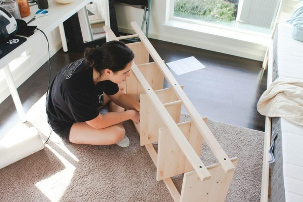 Homeowner assembling furniture as part of a budget-friendly DIY HDB renovation.