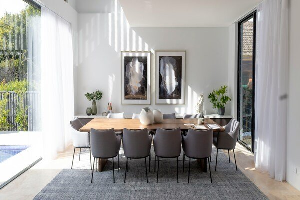 A photo of a dining table with chairs around it