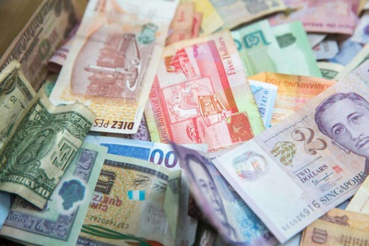 Assorted local and foreign currencies representing smart money management and budgeting habits.
