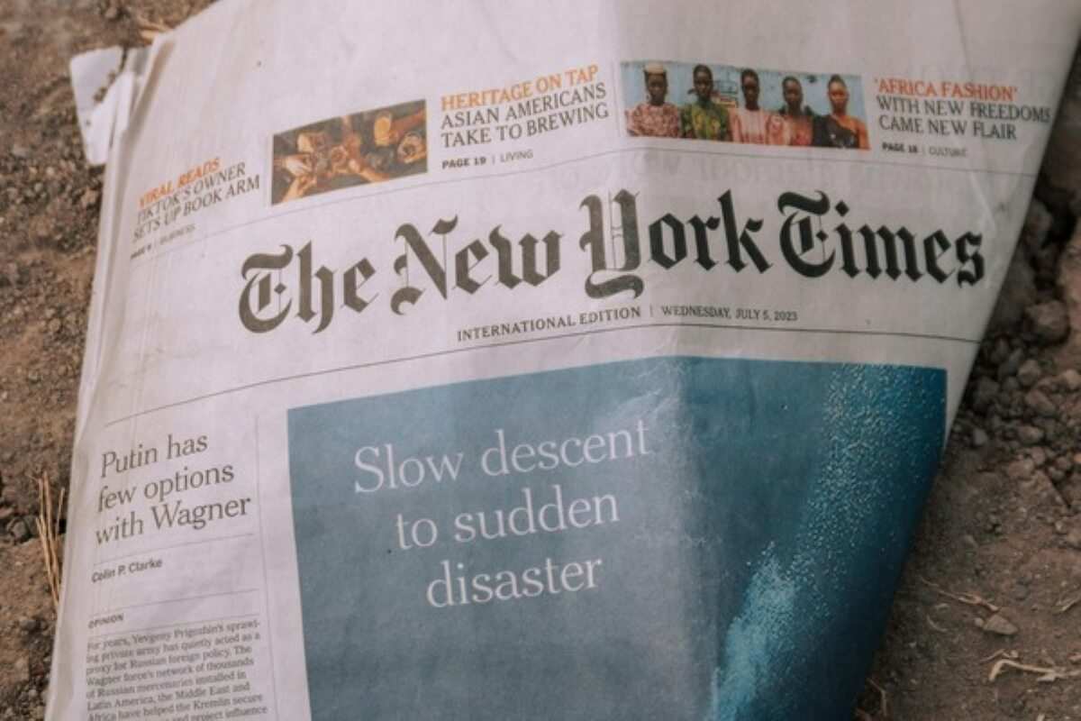 Newspaper featuring global economic headlines, representing the market impact of trump tariff on consumers and investors.
