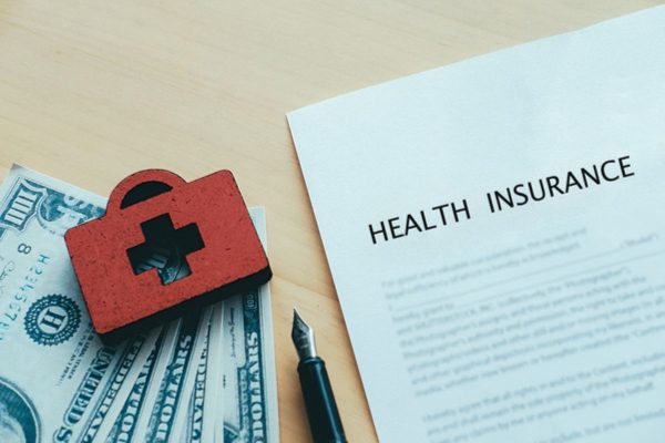 Health insurance policy documents and medical expenses illustrating the benefits of an integrated shield plan.