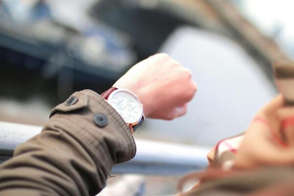 A photo of a person looking at a wrist watch
