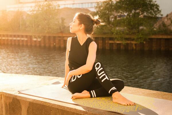 A photo of a woman wearing black fitness outfit doing yoga