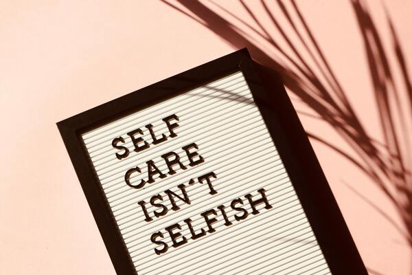 A photo of a self care isn't selfish signage