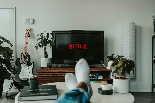A black flat tv screen turned on to Netflix
