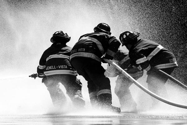 A grayscale photo of a group of firemen
