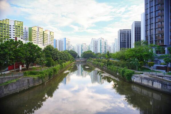 A photo of an urban landscape with modern buildings and a river