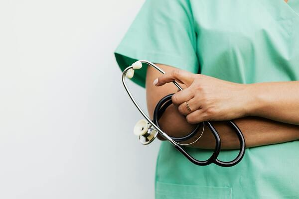 Person holding a stethoscope