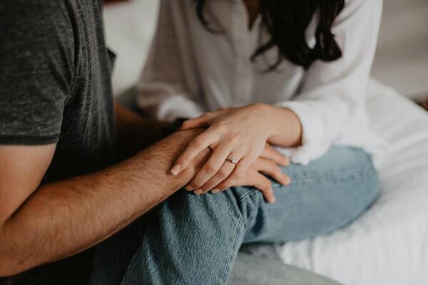 Woman holding a man’s hand