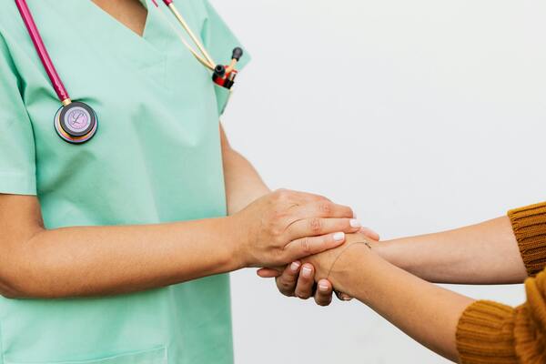 Doctor and patient shaking hands in a clinic setting
