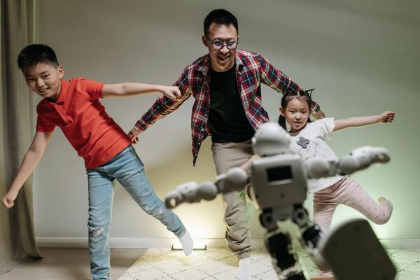 Happy family dancing with the robot