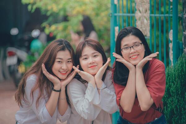 Three girls wearing white and red dress shirts