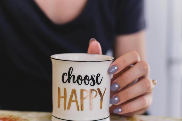 White ceramic mug with choose happy graphic