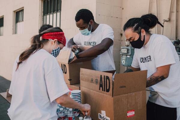 Group of volunteers boxing relief goods