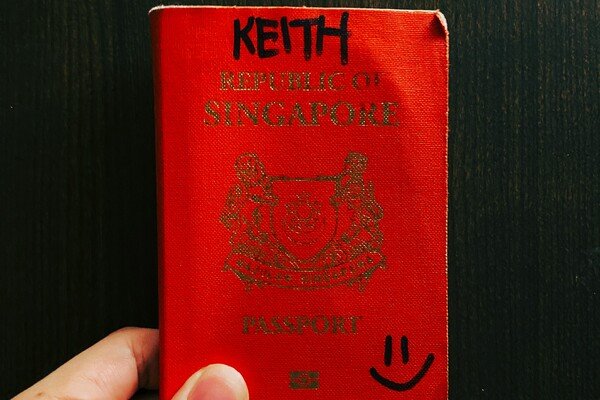 Close-up of hands holding a red book
