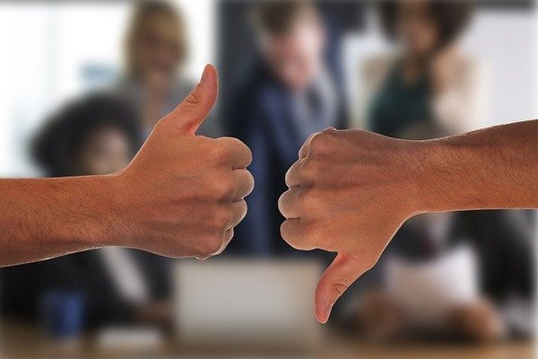 Thumbs up and thumbs down gesture.